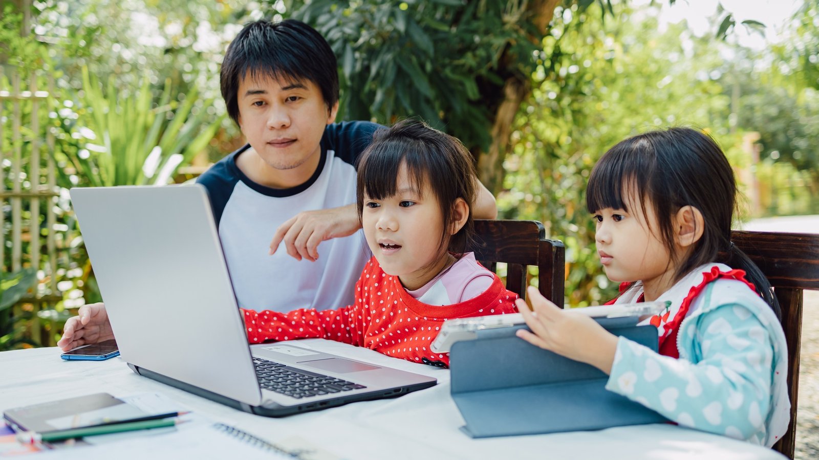 father and preschool daughter use computer for study coding computer at home