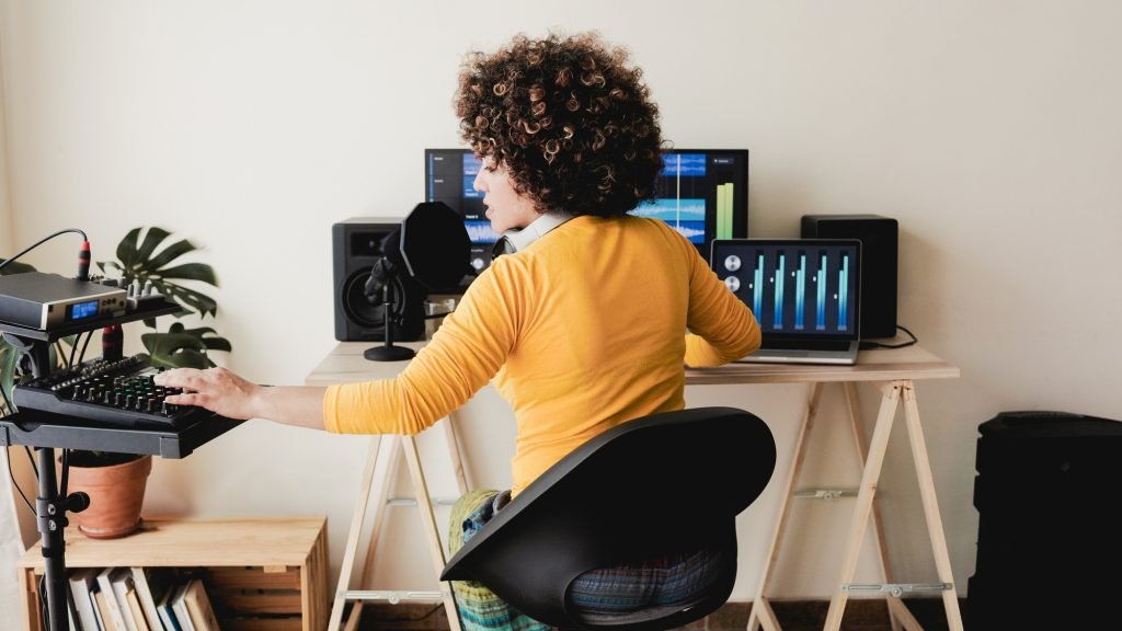 Music producer, Latin artist edit and mix audio album in software in production studio